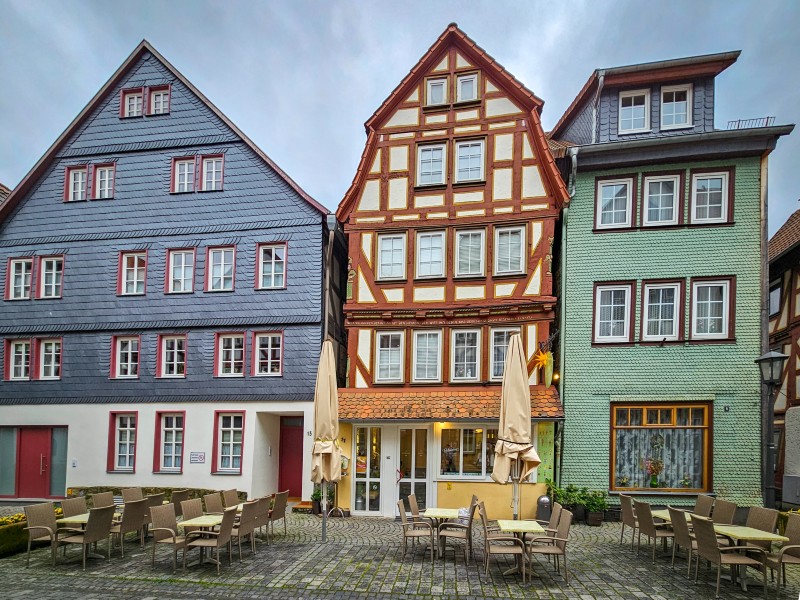 Huis met leistenen gevel, vakwerkhuis, en huis met houten tegeltjes naast elkaar